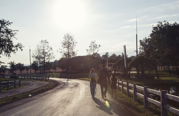 Family walking at sunset