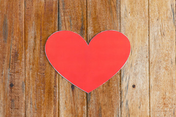 Red paper heart on wooden background with vintage tone, love and valentine concept