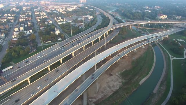 4K video aerial I-10, I-45 freeway, suburban residential houses in Northeast Houston, TX, US. Highway lane under construction, massive intersection, stack interchange, elevated road junction overpass