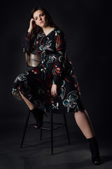 portrait plus size fashion model fat woman on gray studio background, overweight female body.