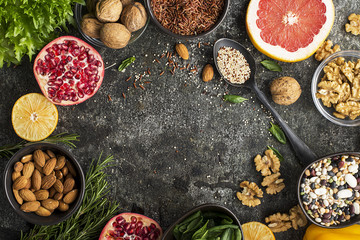 Ingredients of a healthy diet for drawing up a meal plan: wild brown rice, quinoa, spinach, legumes, oranges, grapefruit, almonds, walnuts. Top View .copy space