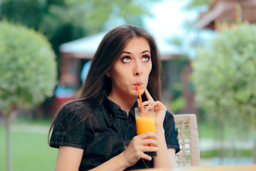 Portrait of a Woman Drinking Orange Juice Outdoors