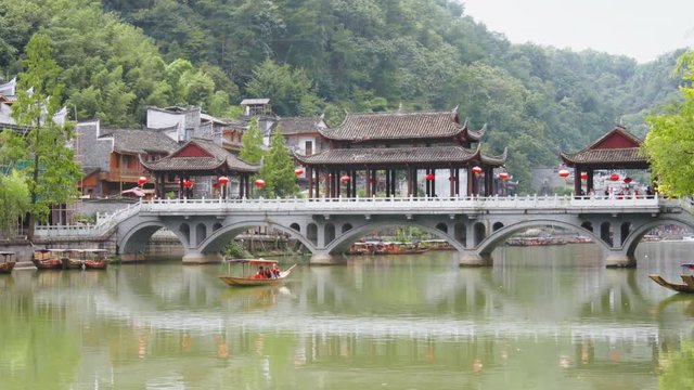 Traditional Chinese boat sailing along the Tuojiang River