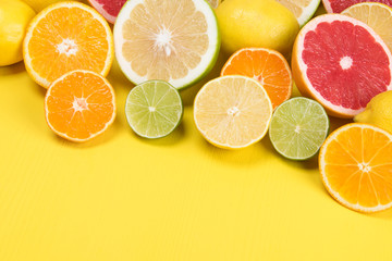 set of yellow and green lemon, orange, grapefruit in a cut on a yellow background