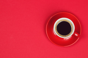 Red coffee cup on red background. Valentines day background. Minimal style. Flat lay, Top view.