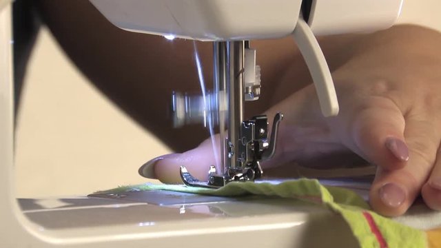 Woman seamstress scribbles on the sewing machine