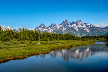 Obraz na płótnie Canvas Mountains in Grand Teton National Park with reflection in Snake River