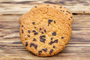 Cookies with chocolate on wooden table.