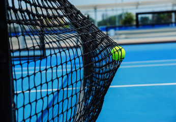 tennis balls in black net