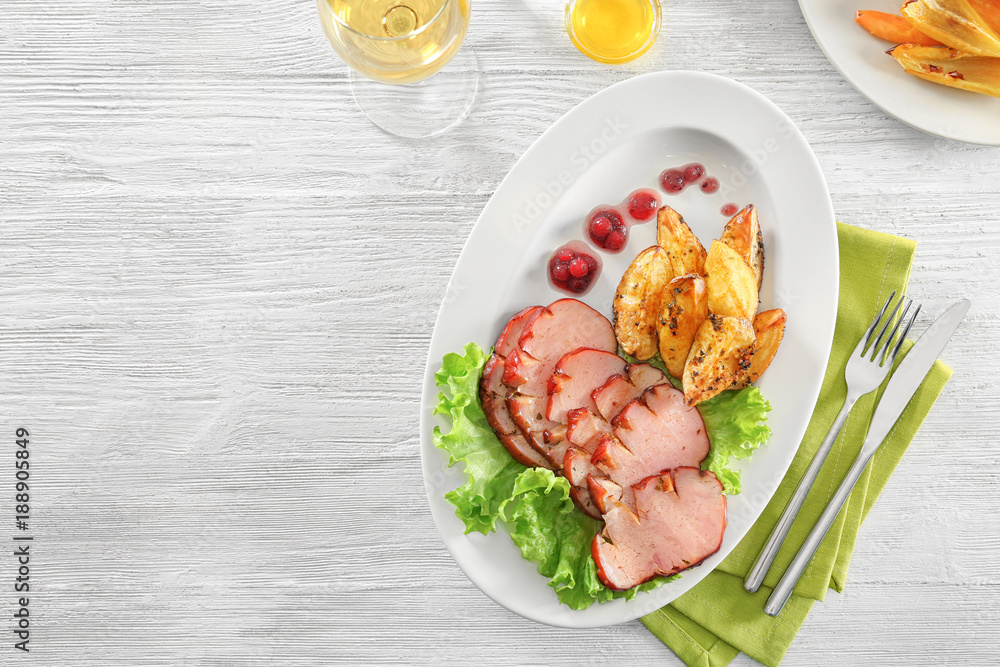 Poster Plate with sliced honey baked ham and potato on wooden table