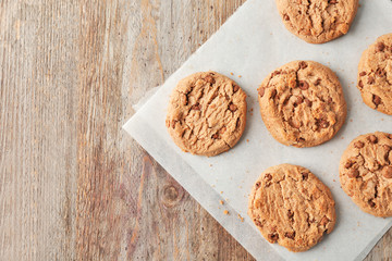 Delicious oatmeal cookies with chocolate chips on wooden table
