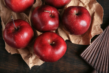 Ripe red apples on wooden background