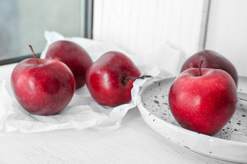 Ripe red apples on windowsill
