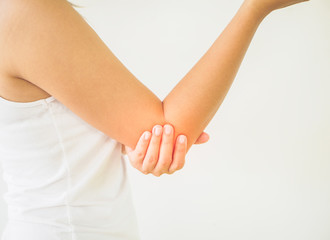Close up woman having pain in injured elbow. Health care and arm pain concept.