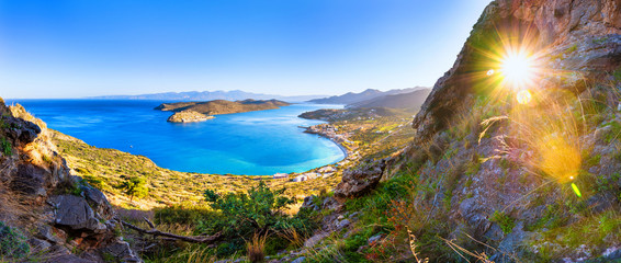 Panoramic view of the gulf of Elounda with Spinalonga island. View from the mountain through a...