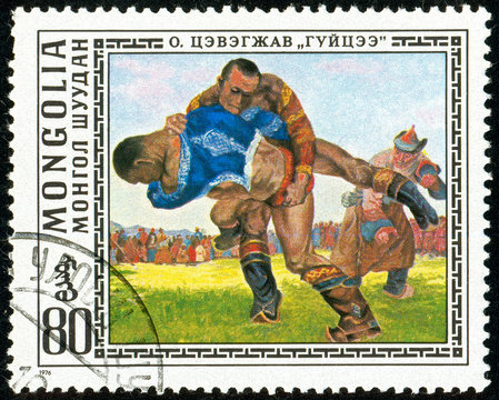 Ukraine - circa 2018: A postage stamp printed in Mongolia show Wrestlers. Mongolian National Sport. Series: Paintings by O. Cevegshava. Circa 1976.
