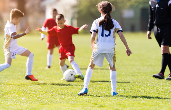 Young children players football match on soccer field