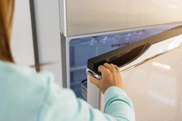 young woman hand opening refrigerator door
