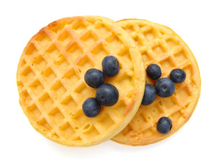 a round waffle and blue berry on a white background
