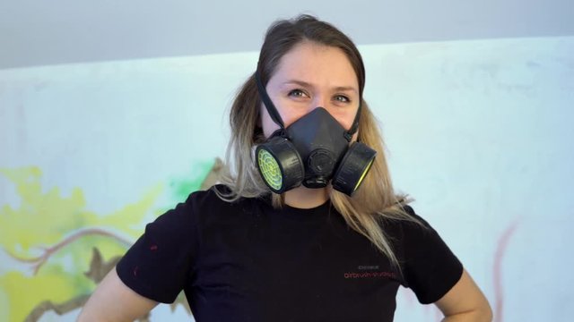 the girl wears a respirator and smiling