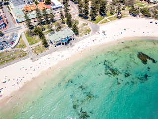 Fototapeta na wymiar Aerial photograph over a busy Cottesloe Beach, Perth, Western Australia, on a clear summer afternoon. 