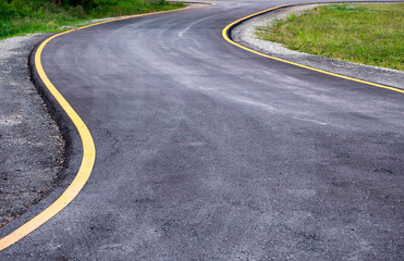 Fototapeta na wymiar Black asphalt road curved