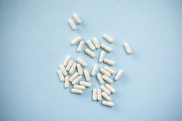 White capsules on blue background