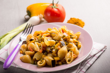 pasta with peas tomatoes capsicum and curry, selective focus