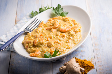 shrimp with curry ginger and coconut sauce, selective focus