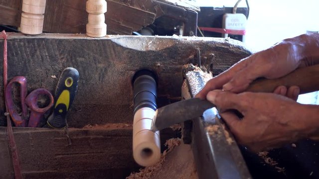 Skilled artisan working of wooden piece