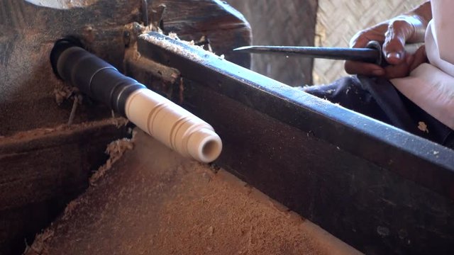 Skilled artisan working of wooden piece