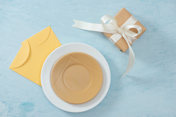 Tet Holiday Concept. Gold Envelope (Lucky money) on table with Table setting with Plate and Flowers.