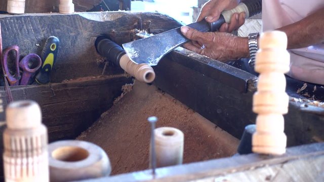 Skilled artisan working of wooden piece