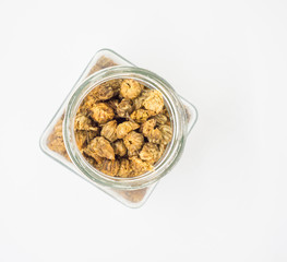 Dried chrysanthemum flowers in Bottle on white background