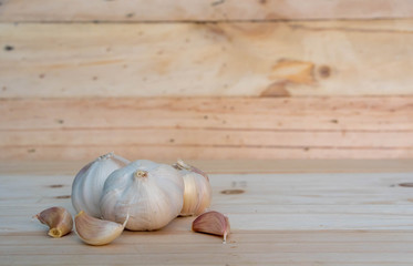Fresh garlic isolated on wooden background.