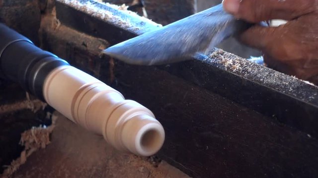 Skilled artisan working of wooden piece