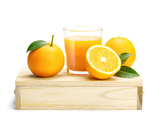 Glass of fresh orange juice with group of orange on a wooden box isolate on white background, Selective focus on glass.