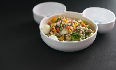 egg vegetable and pork soup on black background