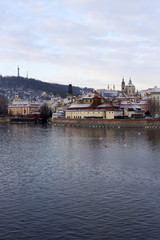 Obraz premium Snowy Prague Lesser Town with St. Nicholas' Cathedral, Czech republic