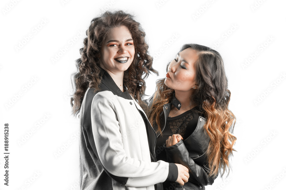 Wall mural portrait of two attractive caucasian and asian smiling women isolated on white studio shot