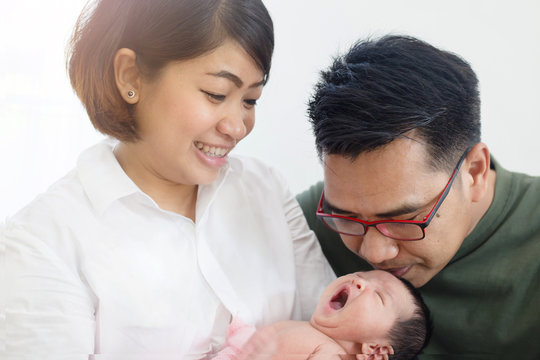 Asian Mother and Father take care their adorable newborn baby carefully