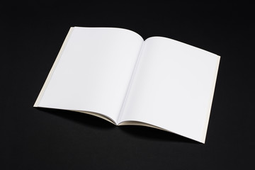 Mock-up magazine, book or catalog on black table. Blank page or notepad on solid background. Blank page or notepad for mockups or simulations.