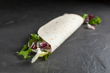 Lavash with herbs with olive oil and spices on a dark background