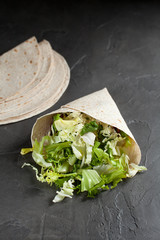 Lavash with herbs with olive oil and spices on a dark background