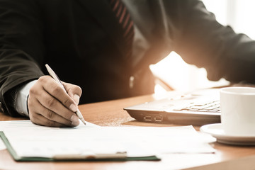 A businessman analyzing investment charts for profit and loss his workplace. Business concept.