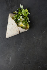 Lavash with herbs with olive oil and spices on a dark background
