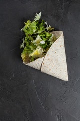 Lavash with herbs with olive oil and spices on a dark background
