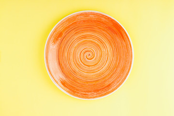 Orange plate on the yellow background