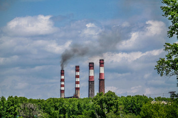 power station's chimneys smoking into the blue sky