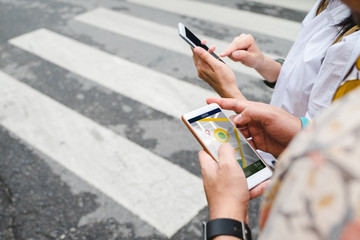 Traveler use map on mobile phone app to search for route location of place with gps on street when...